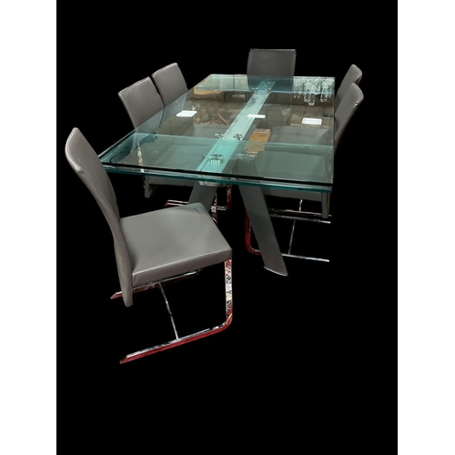 404 - A ROCHE BOBOIS SEVEN PIECE DINING ROOM SUITE comprising draw leaf glazed and chrome dining table on ... 