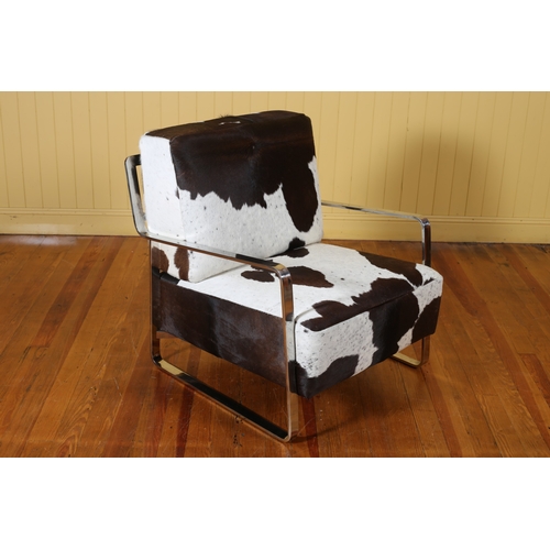 406 - A DESIGNER CHROME AND COW HIDE UPHOLSTERED ARMCHAIR the rectangular back and seat with shaped arms o... 