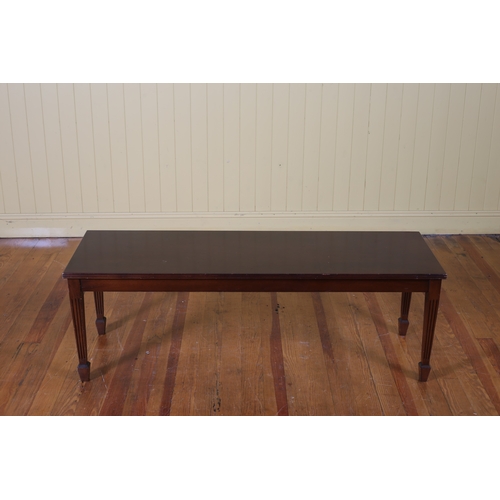 424 - A HEPPLEWHITE STYLE MAHOGANY COFFEE TABLE of rectangular outline the shaped top with reeded rim on t... 