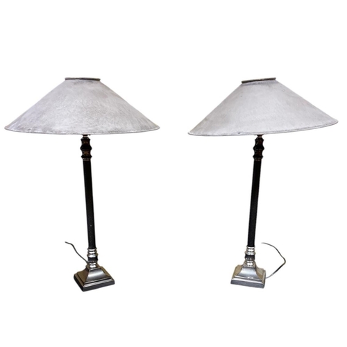 437 - A PAIR OF WHITE METAL TABLE LAMPS each with a cylindrical column above a stepped base with shades 60... 