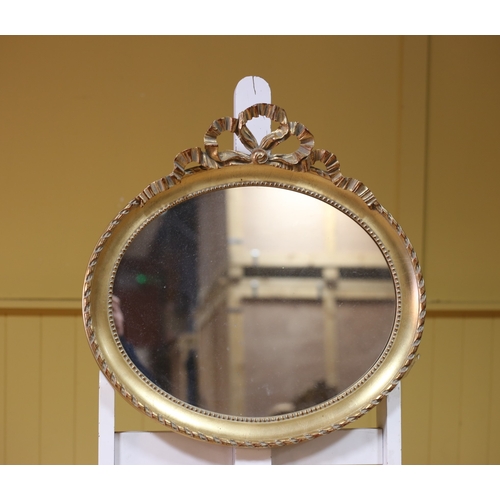 456 - A GILT FRAME MIRROR the oval plate within a beadwork frame with ribbon tied cresting 55cm (h) x 56cm... 