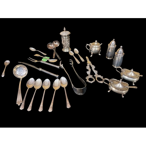 528 - A COLLECTION OF SILVER to include a three piece Celtic pattern condiment set, a silver embossed pepp... 