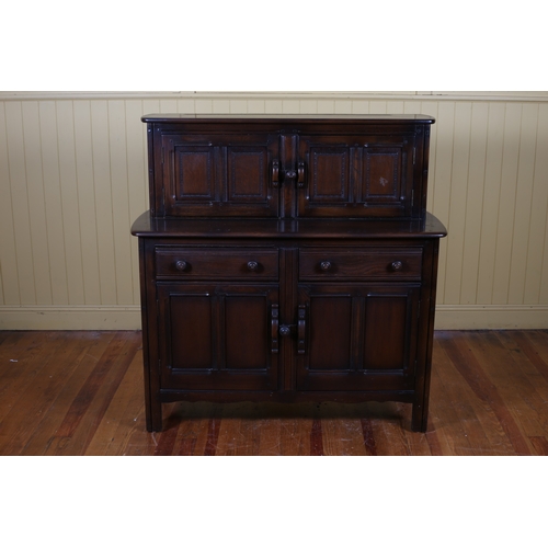 569 - A VINTAGE OAK COURT CUPBOARD the moulded top above a pair of cupboards the base with two frieze draw... 