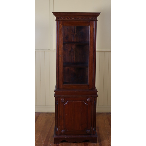 572 - A MAHOGANY DISPLAY CABINET the moulded cornice above a bevelled glazed door containing shelves the b... 