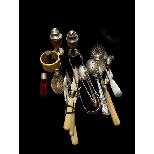 609 - A MISCELLANEOUS COLLECTION to include a silver sugar nips, a ruby and silver top perfume bottle, two... 