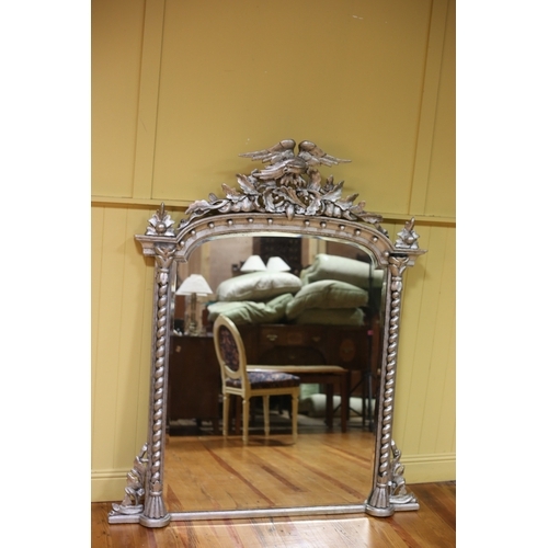 499 - A 19TH CENTURY CARVED WOOD SILVER FRAME OVERMANTEL MIRROR the rectangular arched bevelled glass plat... 