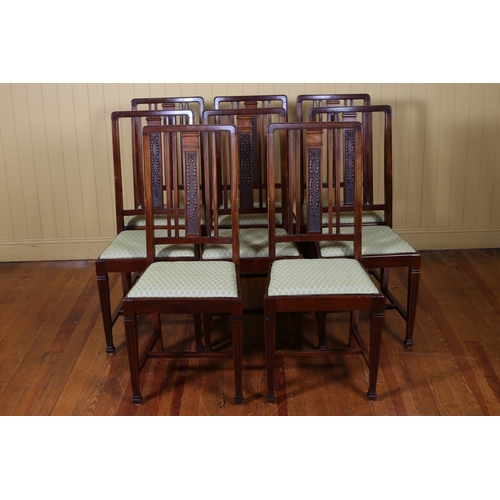 91 - A SET OF EIGHT VINTAGE CARVED MAHOGANY DINING CHAIRS each with a shaped back centred by a laurel wre... 