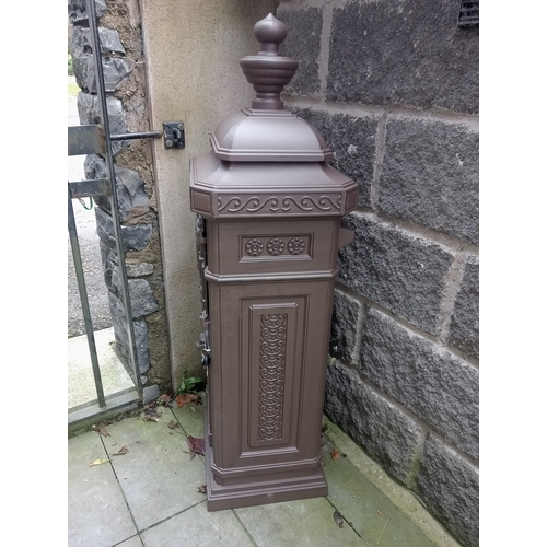 224 - AN ALUMINIUM FREESTANDING POSTBOX of rectangular outline with urn finial and hinged door on platform... 