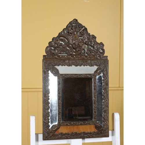 313 - A 19TH CENTURY CONTINENTAL BRASS FRAME COMPARTMENT MIRROR embossed with C-scrolls and foliage with f... 