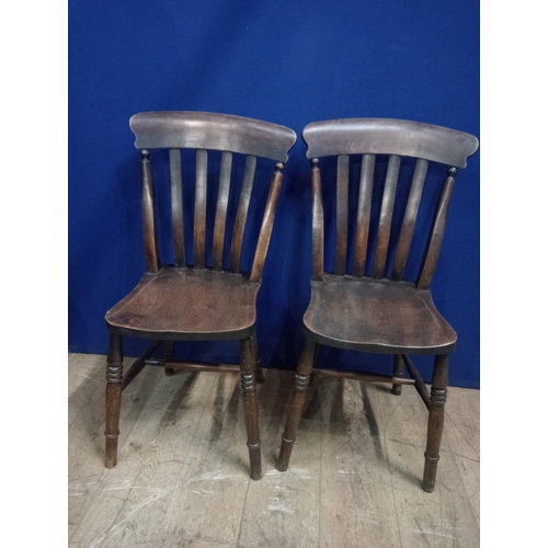 369 - A PAIR OF VINTAGE STAINED ELMWOOD CHAIRS each with a curved top rail and vertical splats with shaped... 