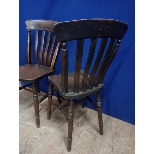 369 - A PAIR OF VINTAGE STAINED ELMWOOD CHAIRS each with a curved top rail and vertical splats with shaped... 