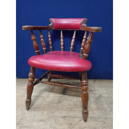 468 - A STAINED BEECHWOOD AND UPHOLSTERED SMOKERS CHAIR the curved back with upholstered panel and seat on... 