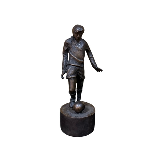 492 - JARLATH DALY A cast bronze sculpture modelled as a Footballer shown standing on a circular base Limi... 