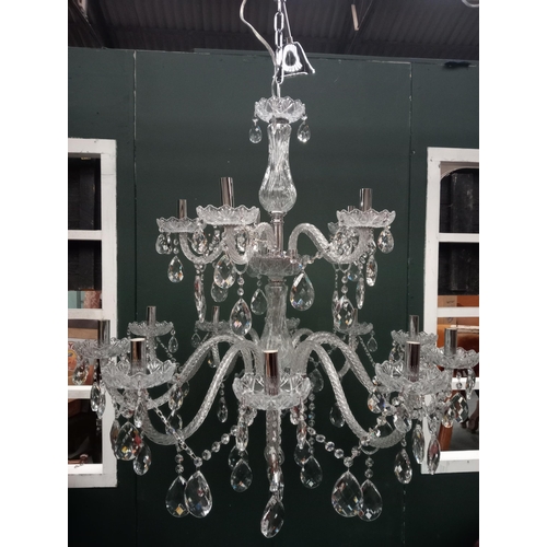 586 - A CONTINENTAL TWELVE BRANCH CUT GLASS CHANDELIER in two registers hung with faceted chains and penda... 