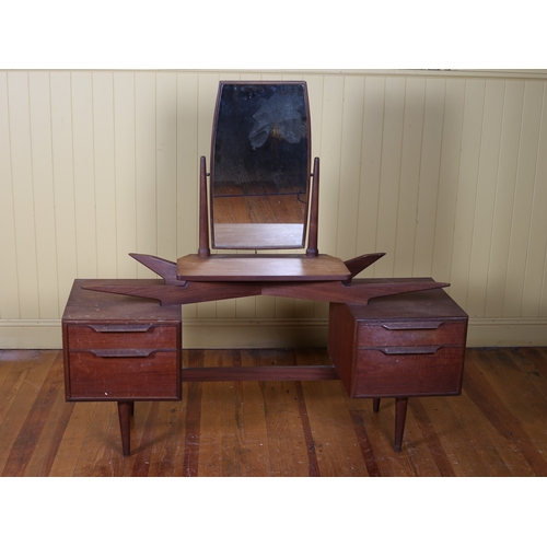 18 - A VINTAGE TEAK DRESSING TABLE the superstructure with swivel mirror above a glazed top on twin two d... 