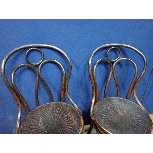 233 - A PAIR OF VINTAGE BENTWOOD CHAIRS each of typical form with embossed panelled seats