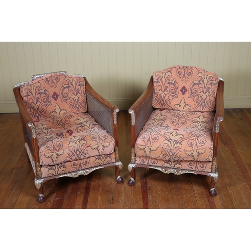 242 - A THREE PIECE WALNUT AND PARCEL GILT BERGERE SUITE with loose cushions comprising a two seater sette... 