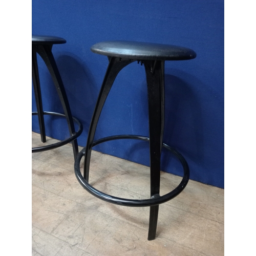 255 - A SET OF FOUR TUBULAR STEEL HIGH STOOLS the circular seat's on shaped supports joined by a tubular s... 