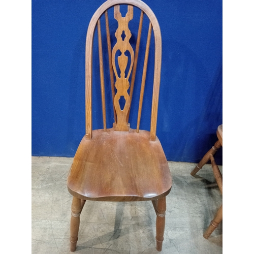 279 - A SET OF SIX ELMWOOD WINDSOR DINING CHAIRS each with a curved top rail and pierced vertical splat wi... 