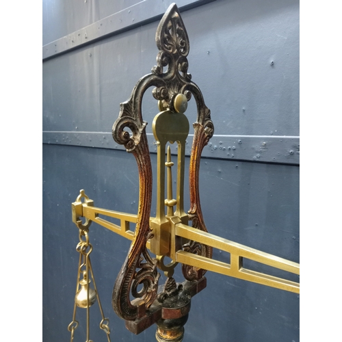 281 - A VICTORIAN BRASS AND CAST IRON WEIGH SCALES the cylindrical column with lyre capital issuing a rect... 