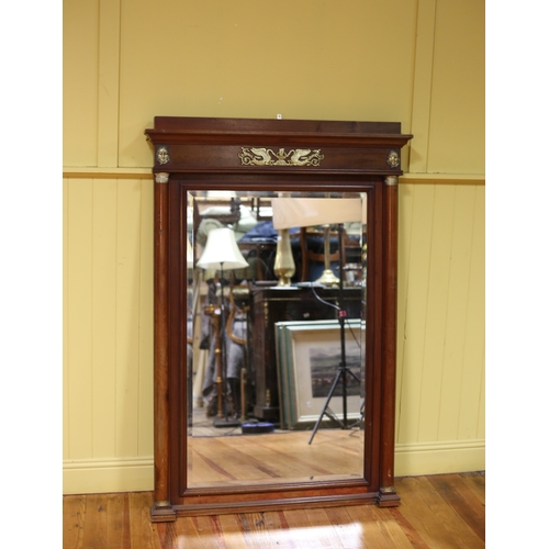 307 - AN EMPIRE STYLE MAHOGANY AND GILT BRASS MOUNTED MIRROR the rectangular bevelled glass plate within a... 