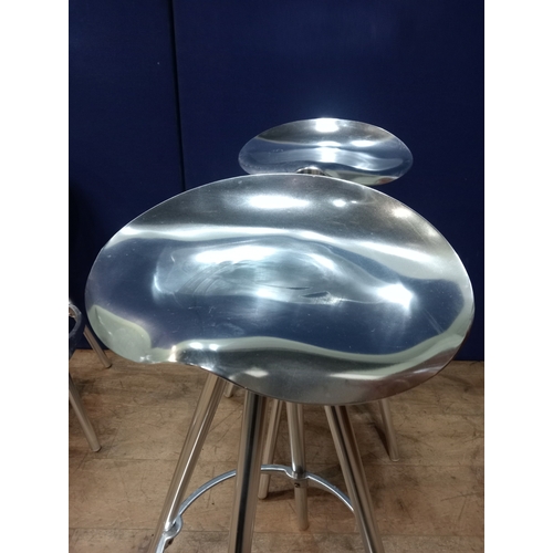 332 - A SET OF FOUR WHITE METAL REVOLVING HIGH STOOLS each with a saddle seat raised on four tubular legs ... 