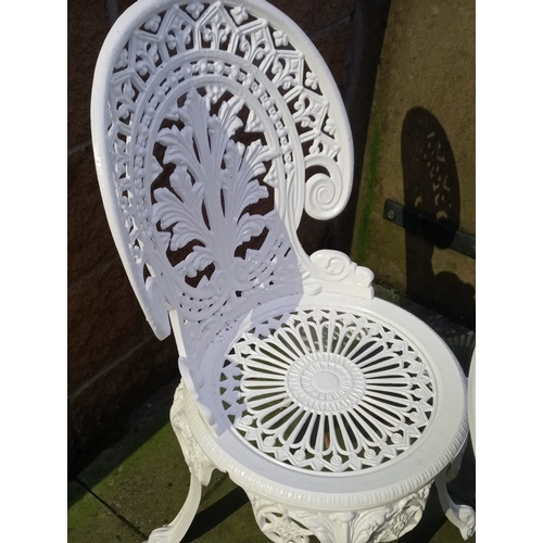 344 - A THREE PIECE CAST ALUMINIUM PATIO SUITE comprising a pair of chairs each with a pierced shaped back... 