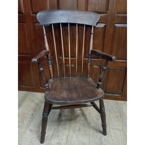 359 - A VINTAGE OAK ARMCHAIR the shaped top rail above a shaped seat with vertical splats and scroll arms ... 