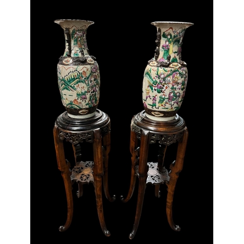 375 - A PAIR OF CHINESE VASES each of baluster form the off white ground decorated overall with figures 12... 