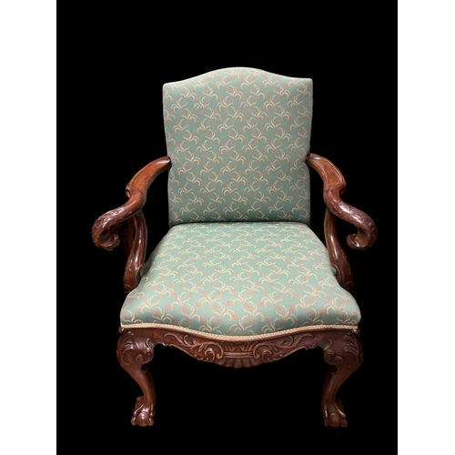 397 - A CHIPPENDALE STYLE MAHOGANY AND UPHOLSTERED ARMCHAIR the rectangular shaped back and seat with foli... 