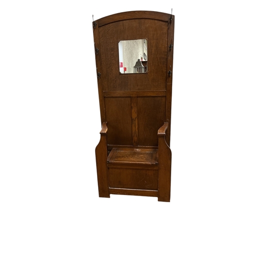 4 - A VINTAGE OAK HALLSTAND the rectangular arched back centred by a mirror flanked on each side by thre... 