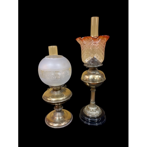 410 - A 19TH CENTURY BRASS OIL LAMP the clear glass and ruby glass shade above a bulbous reservoir with a ... 