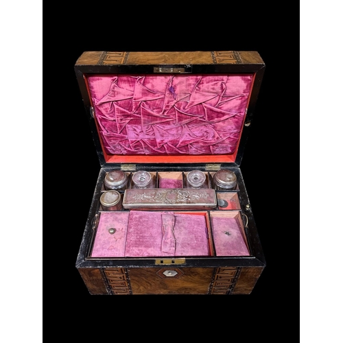 419 - A 19TH CENTURY WALNUT INLAID WRITING CASE the hinged lid containing a fitted interior with pen trays... 