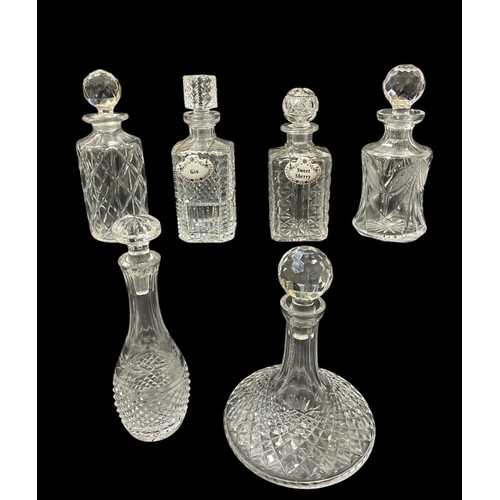 473 - SIX CUT GLASS DECANTERS with two porcelain spirit labels inscribed 'Gin' and 'Sweet Sherry'