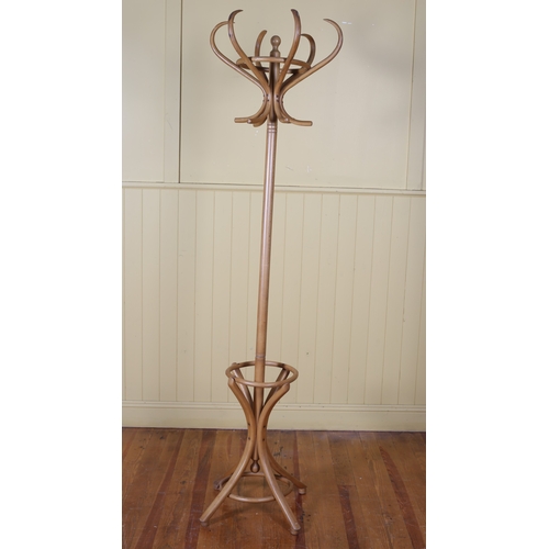 48 - A BENTWOOD HAT COAT AND STICK STAND raised on quadruped ring turned supports with foliate carved spl... 