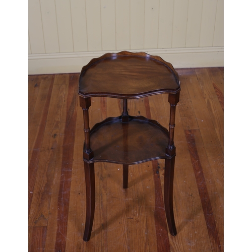 49 - A MAHOGANY TWO TIER OCCASIONAL TABLE of demi lune outline the shaped top with pie crust gallery abov... 