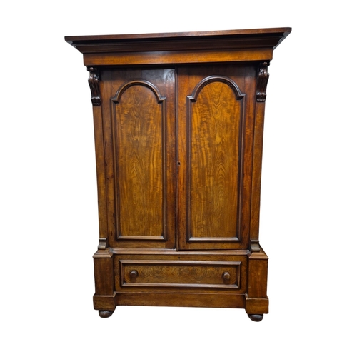 53 - A VICTORIAN MAHOGANY WARDROBE the out swept moulded cornice above a pair of panel doors containing h... 