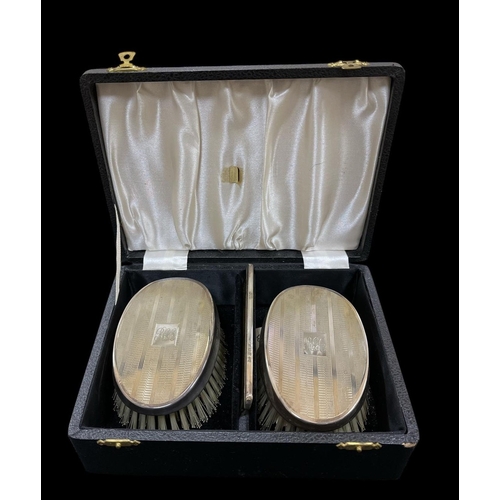 535 - A THREE PIECE SILVER ENGINE TURNED BRUSH AND COMB SET in case Birmingham 1968 comprising a pair of b... 