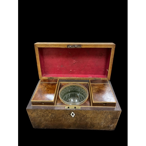 538 - A 19TH CENTURY WALNUT TEA CADDY of rectangular outline the hinged lid containing two lidded caddies ... 