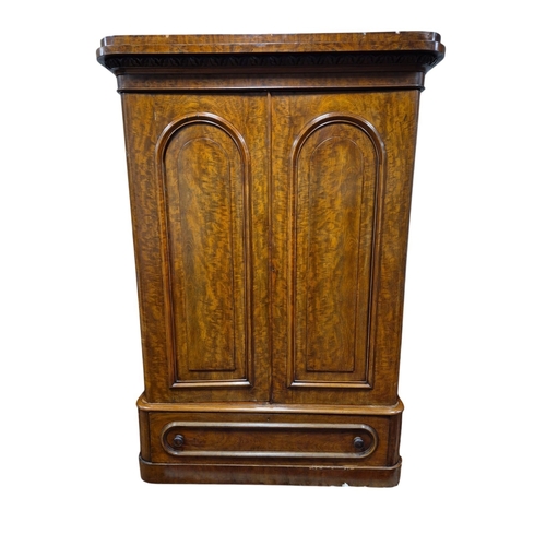 54 - A VICTORIAN MAHOGANY WARDROBE with egg and dart cornice above a pair of arched panel doors containin... 