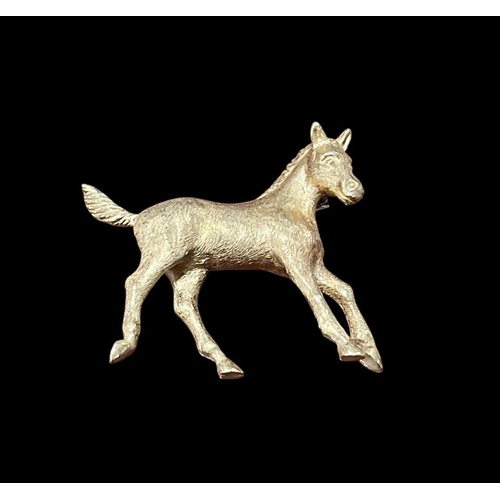 544 - A GILT BROOCH designed as a  horse