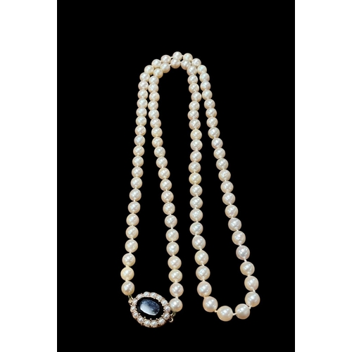 550 - A CULTURED PEARL NECKLACE with 9ct gold and garnet clasp 80cm (l)