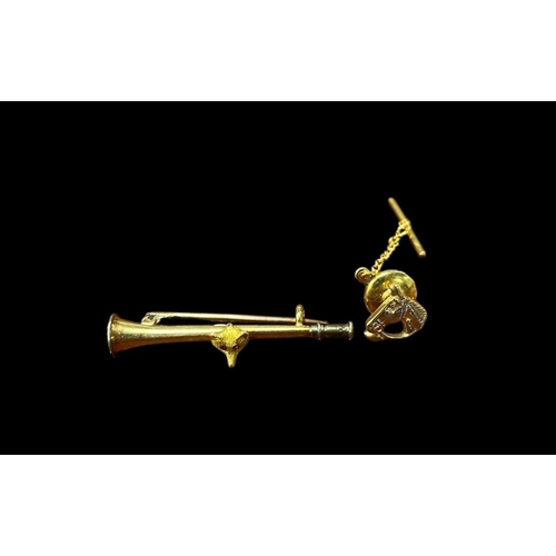 553 - A 15CT GOLD BAR BROOCH in the form of a hunting horn with fox head mount, A 9CT GOLD PIN with horse ... 