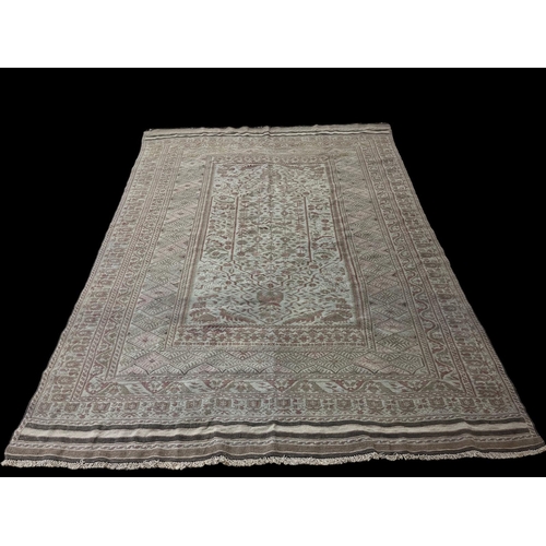 581 - AN ORIENTAL WOOL RUG the multicoloured ground with central panel filled with stylised flowerheads an... 