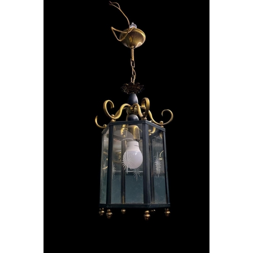 635 - A BRASS AND CLEAR GLASS SINGLE LIGHT LANTERN of octagonal form with scroll arms 40cm drop