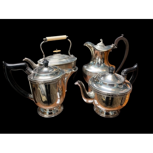 643 - A TWO PIECE SILVER PLATED TEA AND COFFEE SERVICE, a silver plated lidded jug, a plated spirit kettle... 