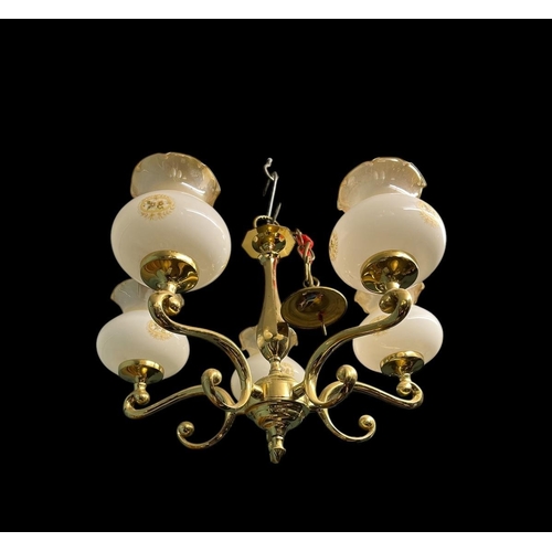 644 - A PAIR OF BRASS SIX BRANCH CHANDELIERS each with a faceted column issuing six scroll arms with glaze... 