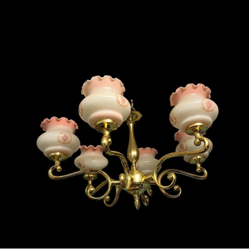 644 - A PAIR OF BRASS SIX BRANCH CHANDELIERS each with a faceted column issuing six scroll arms with glaze... 