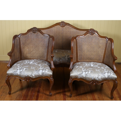 69 - A CONTINENTAL WALNUT AND UPHOLSTERED THREE PIECE BERGERE SUITE comprising a two seater settee the se... 