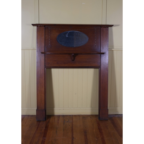 10 - A VINTAGE OAK FIRE SURROUND of rectangular outline with moulded shelves centred by an oval bevelled ... 